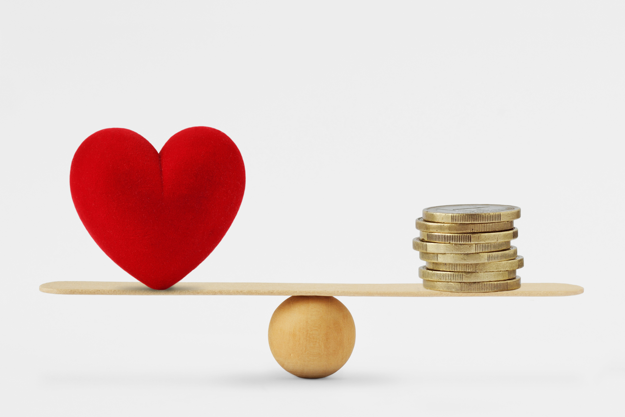 Heart and money on balance scale - Order of priority in life among love and money - Baller Alert Building a Future Together: The Importance of Financial Compatibility in Relationships
