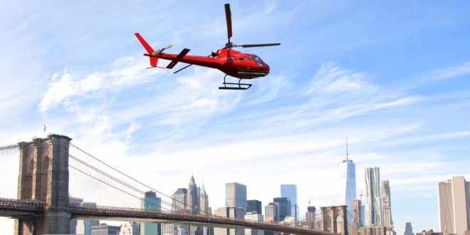 Uber Helicopter flying over New York City skyscrapers and Brooklyn Bridge, USA