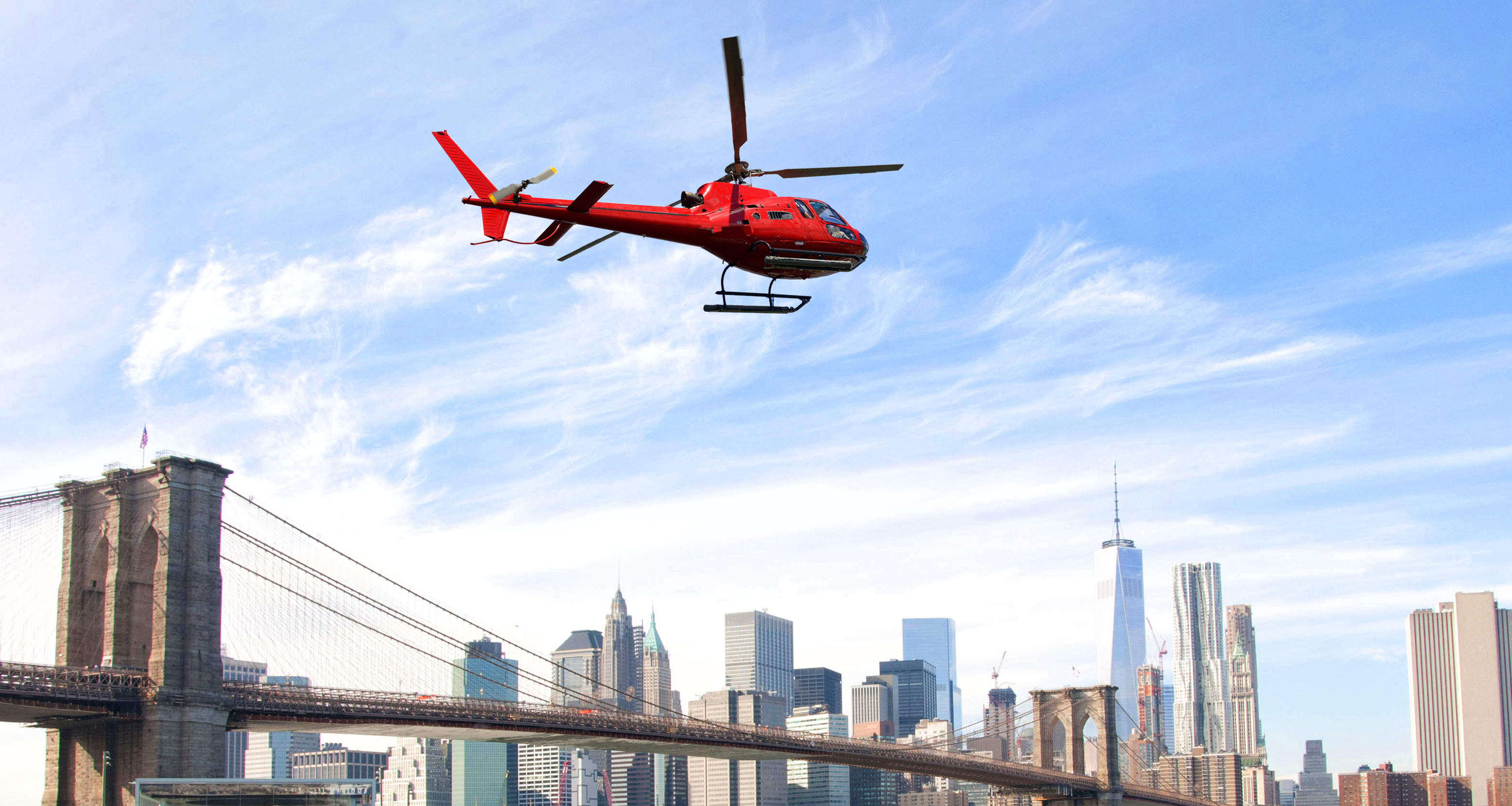Uber Helicopter flying over New York City skyscrapers and Brooklyn Bridge, USA