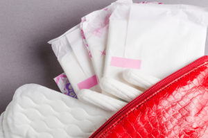 Menstrual tampons and pads in cosmetic bag. Menstruation time. Hygiene and protection - Baller Alert free pads and tampons in Scotland
