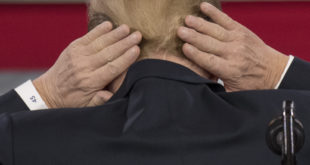 Trump adjusts his hair