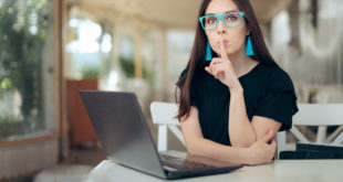 Woman With Finger on the Lips Looking at Laptop catfish