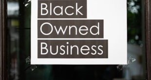Black owned business sign attached on the window
