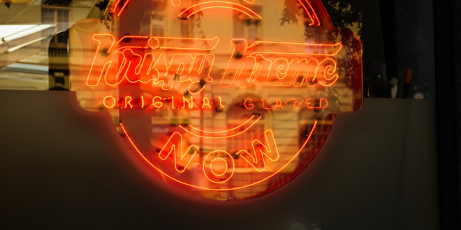 Krispy Kreme Sign With Building Reflection