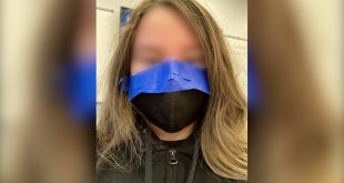 Student with mask taped to face.
