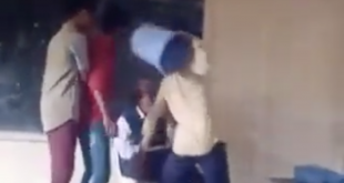 Students allegedly hitting teacher with trash can.