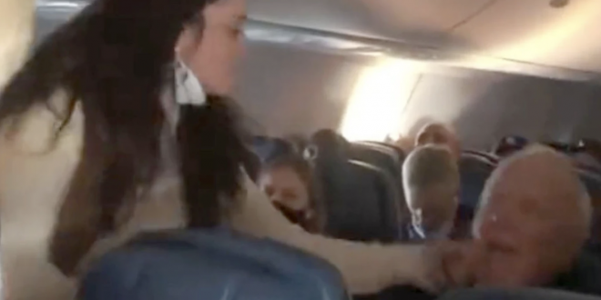 Woman allegedly slapping man on plane.