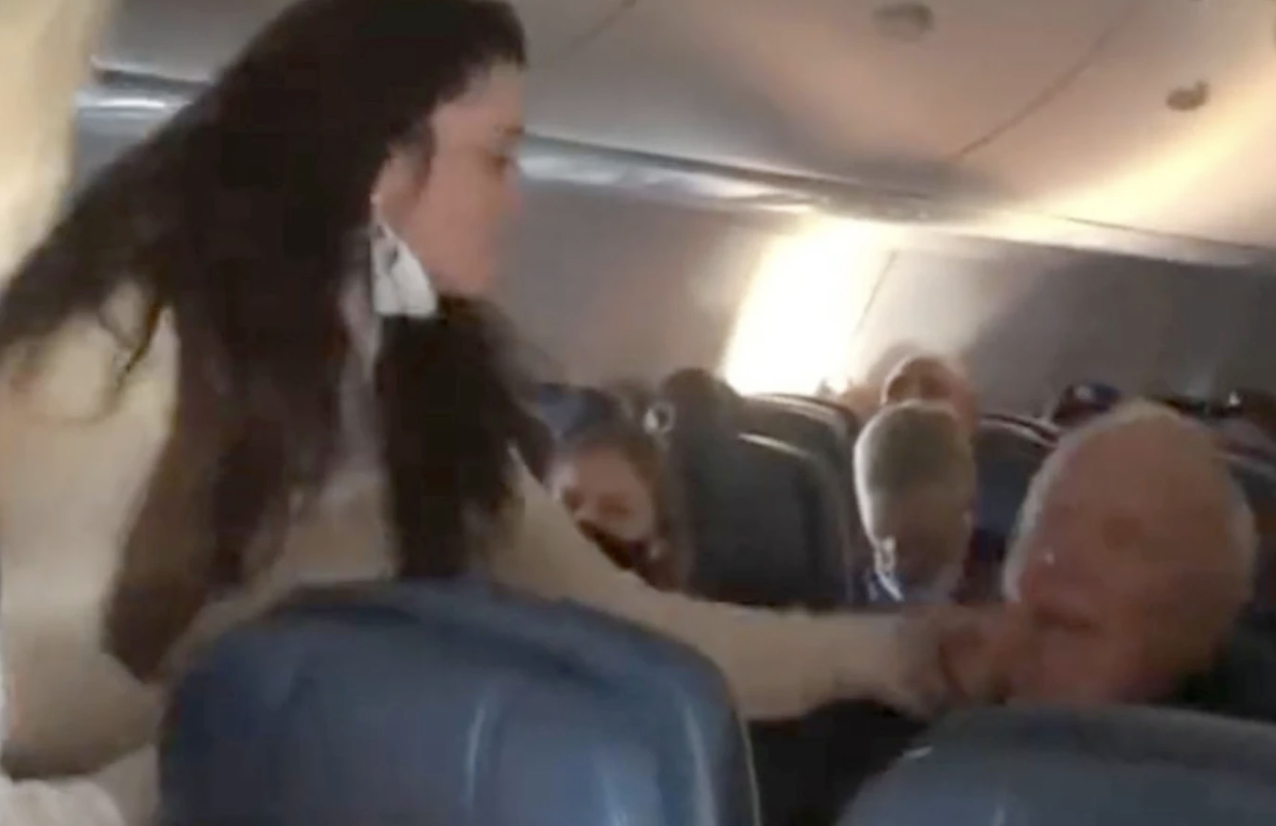 Woman allegedly slapping man on plane.