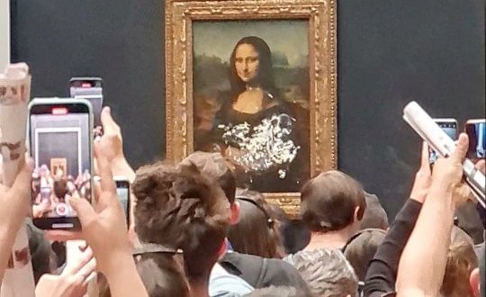 A Man Disguised As An Elderly Woman In A Wheelchair Smeared Cake All Over The Mona Lisa