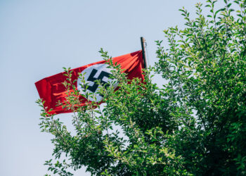 Masked Men Chanting Hate Speech Wave Nazi Flags Outside The Diary of Anne Frank Show in Michigan