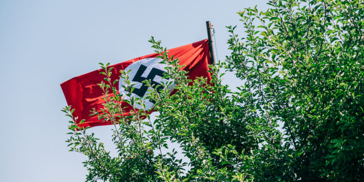 Masked Men Chanting Hate Speech Wave Nazi Flags Outside The Diary of Anne Frank Show in Michigan