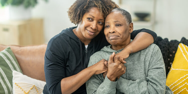 Mother Daughter Embrace - Baller Alert istockphoto