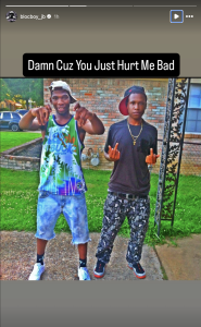 Two young men posing outside a brick building; caption says 'Damn Cuz You Just Hurt Me Bad'.