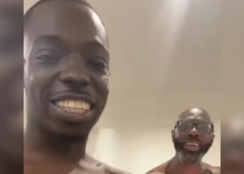 Bobby Shmurda dad smiling beside the rapper after prison release