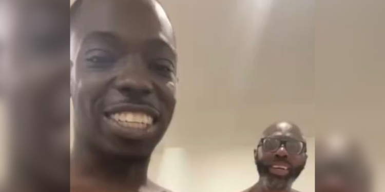 Bobby Shmurda dad smiling beside the rapper after prison release