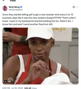 - Baller Alert Woman in a white chef cap and red apron in a kitchen, looking at the camera while handling a utensil (GIF).