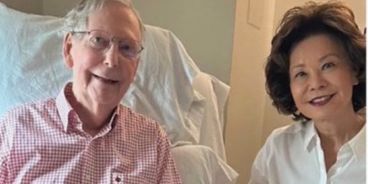 Mitch McConnell sitting in a rehabilitation bed beside his wife Elaine Chao in a photo released with his health update