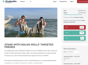 Two men in the water on a boat pose with a long string of fish they just caught, smiling at the camera with the sea behind them.