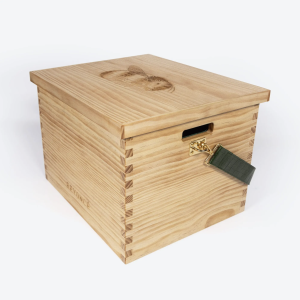Wooden storage box with a gold latch and a green leather strap securing a small lock.