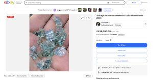 Close-up of blue-green glass crystal fragments held in a hand
