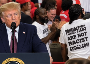 Blacks for Trump supporters stand as Trump speaks at his Chillicothe, Ohio rally