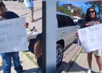 HBCU students protest with signs outside an East Austin home near Huston-Tillotson University