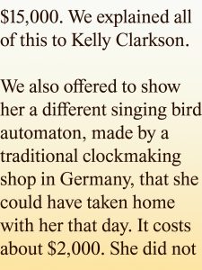 Large serif text on a pale gradient background reading: ',000. We explained all of this to Kelly Clarkson. We also offered to show her a different singing bird automaton, made by a traditional clockmaking shop in Germany, that she could have taken home with her that day. It costs about 
