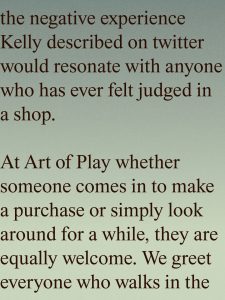 Gradient poster with a long brown serif text about inclusivity in a shop, titled 'At Art of Play' and welcoming everyone who walks in.